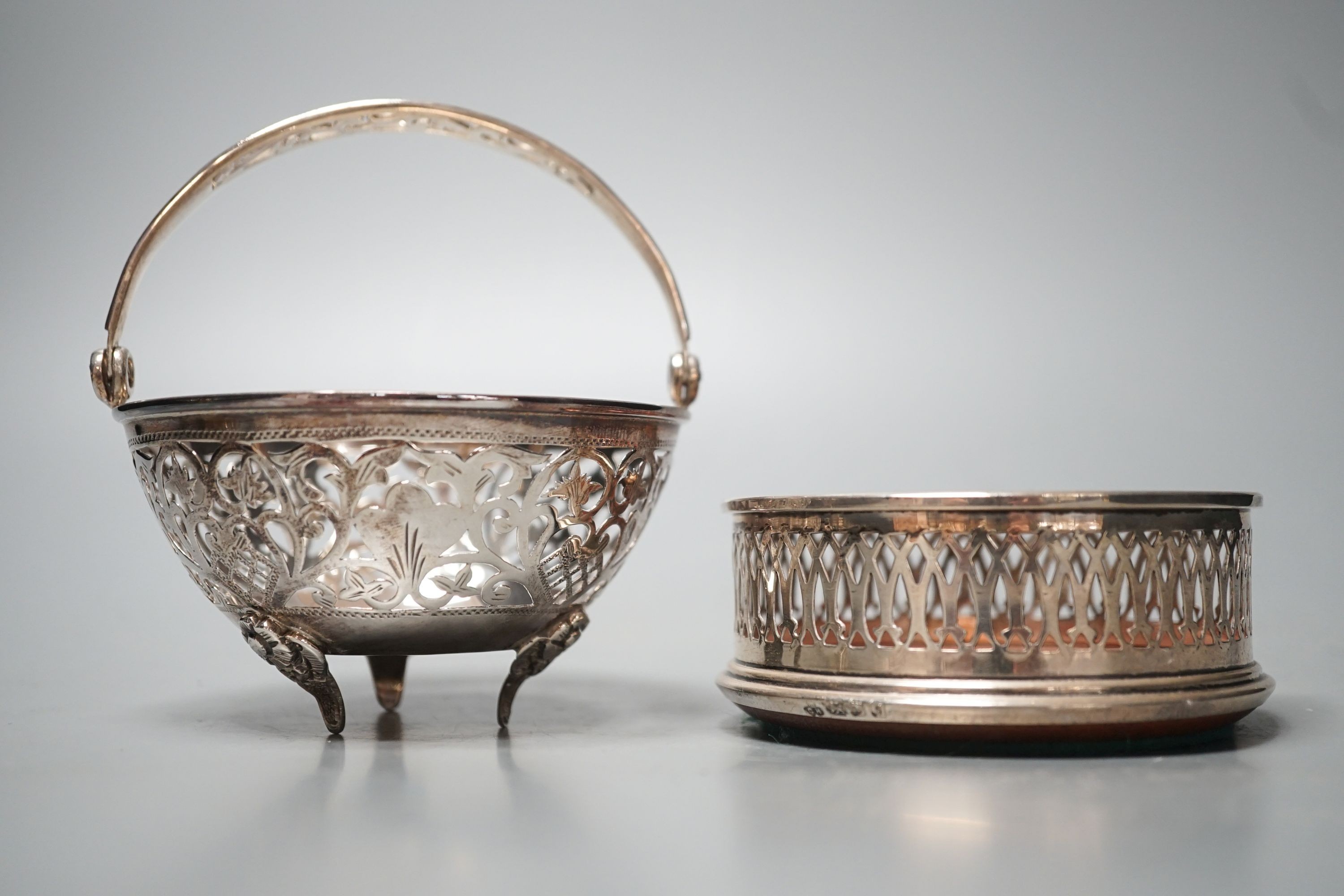 A modern pierced silver sweetmeat basket, 10cm and a similar pierced silver wine coaster.